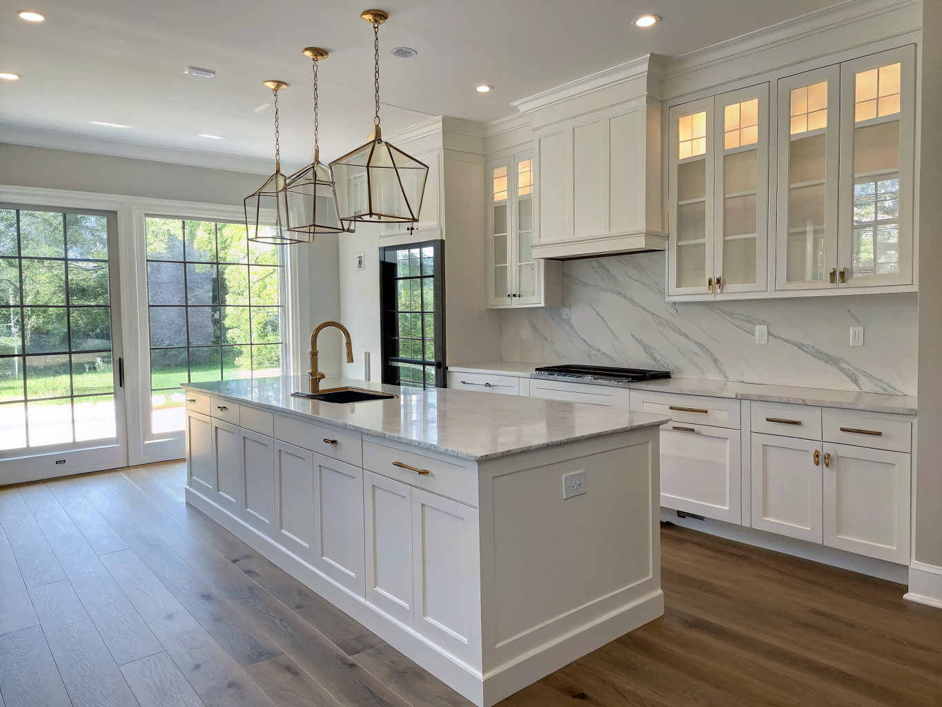 Open concept kitchen remodel in a Mableton ranch home with white shaker cabinets and quartzite island