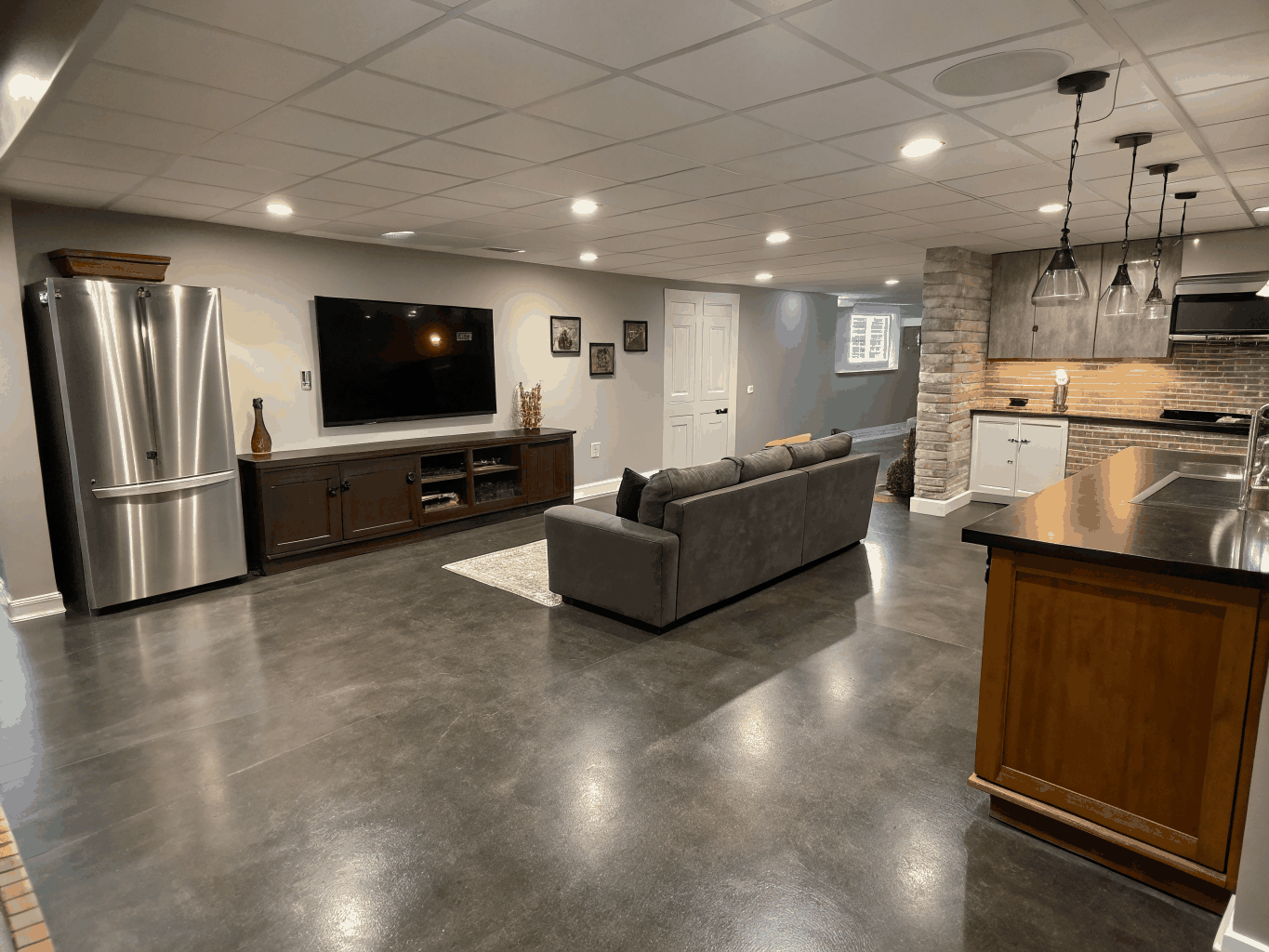 Finished basement living area with recessed lighting, cozy seating, and modern finishes in a Powder Springs home